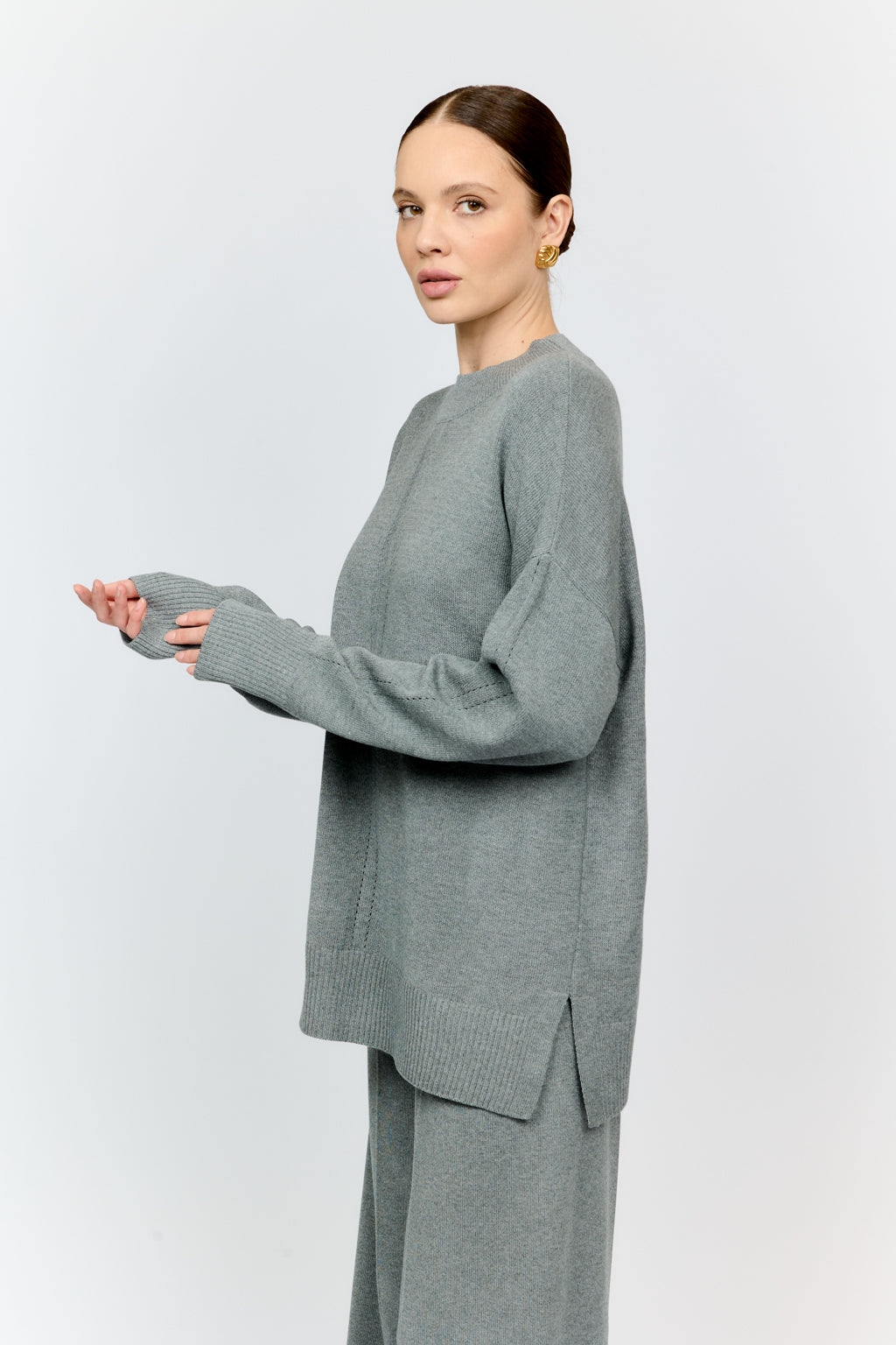 Woman wearing a gray outfit on a white background