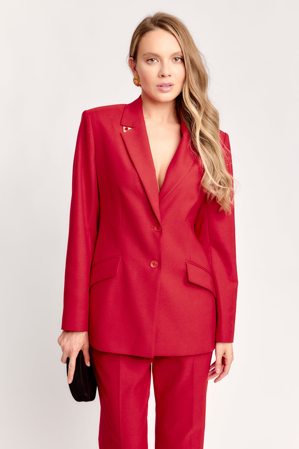 Woman wearing a red suit with a white background