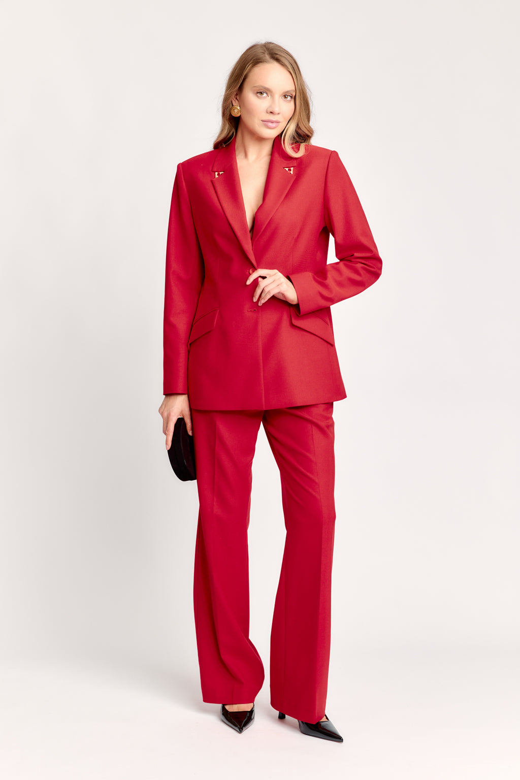 Woman wearing a red suit on a white background