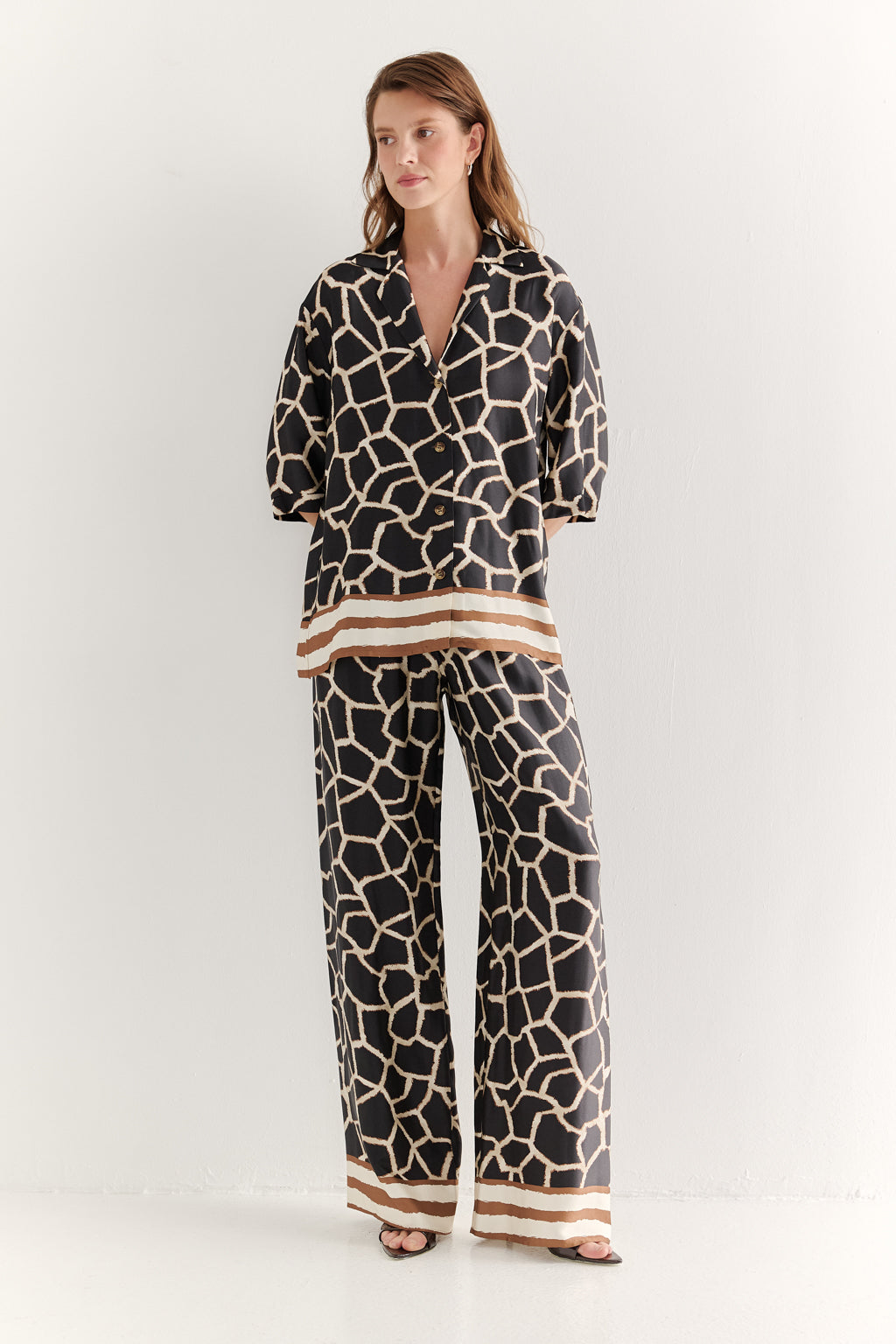 Woman wearing a patterned outfit on a white background