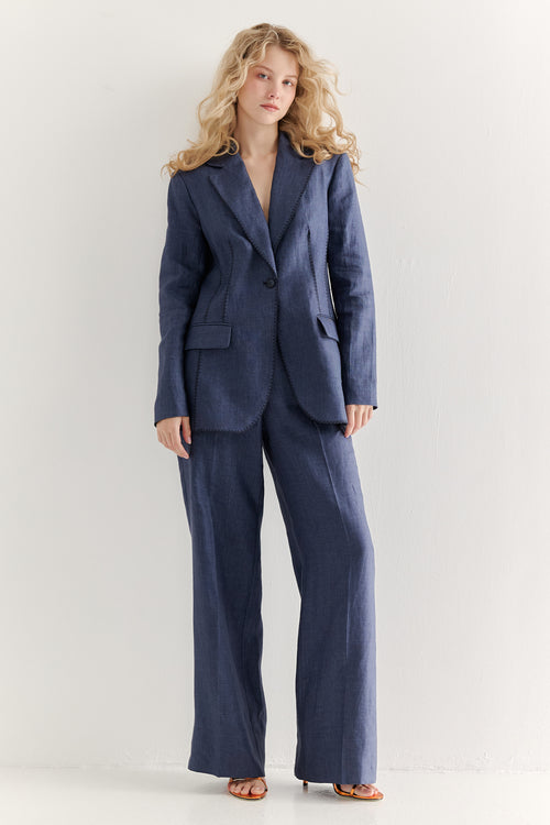 Woman wearing a blue suit against a white background