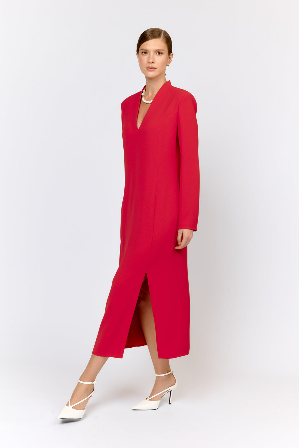 Woman wearing a red dress with a white background