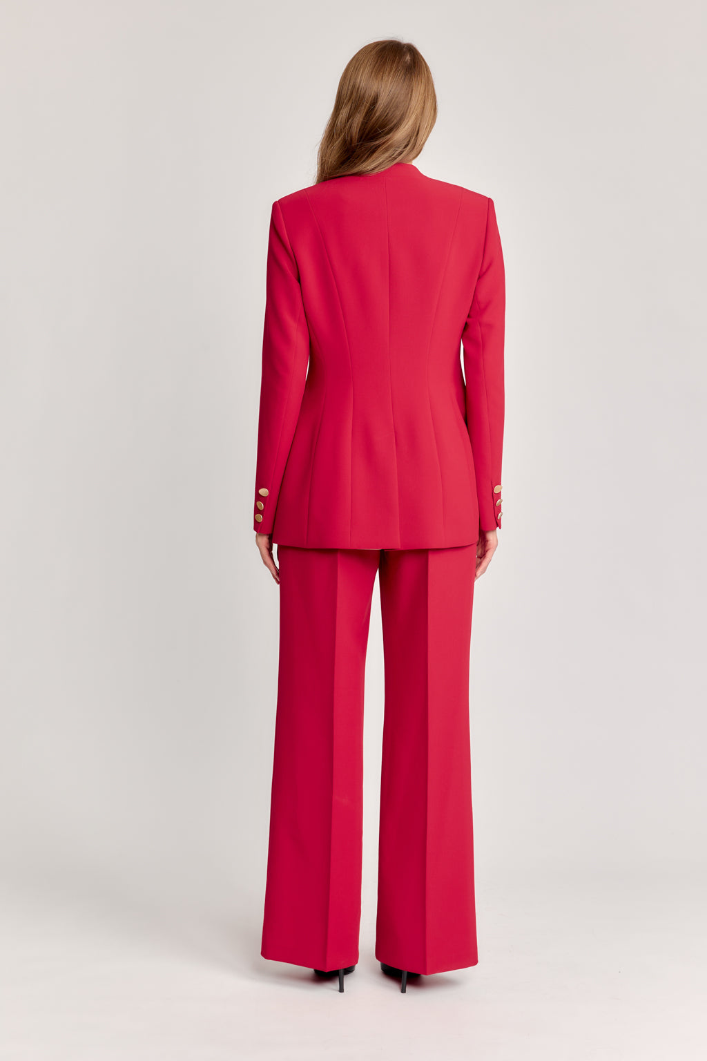 Red suit worn by a person on a light gray background
