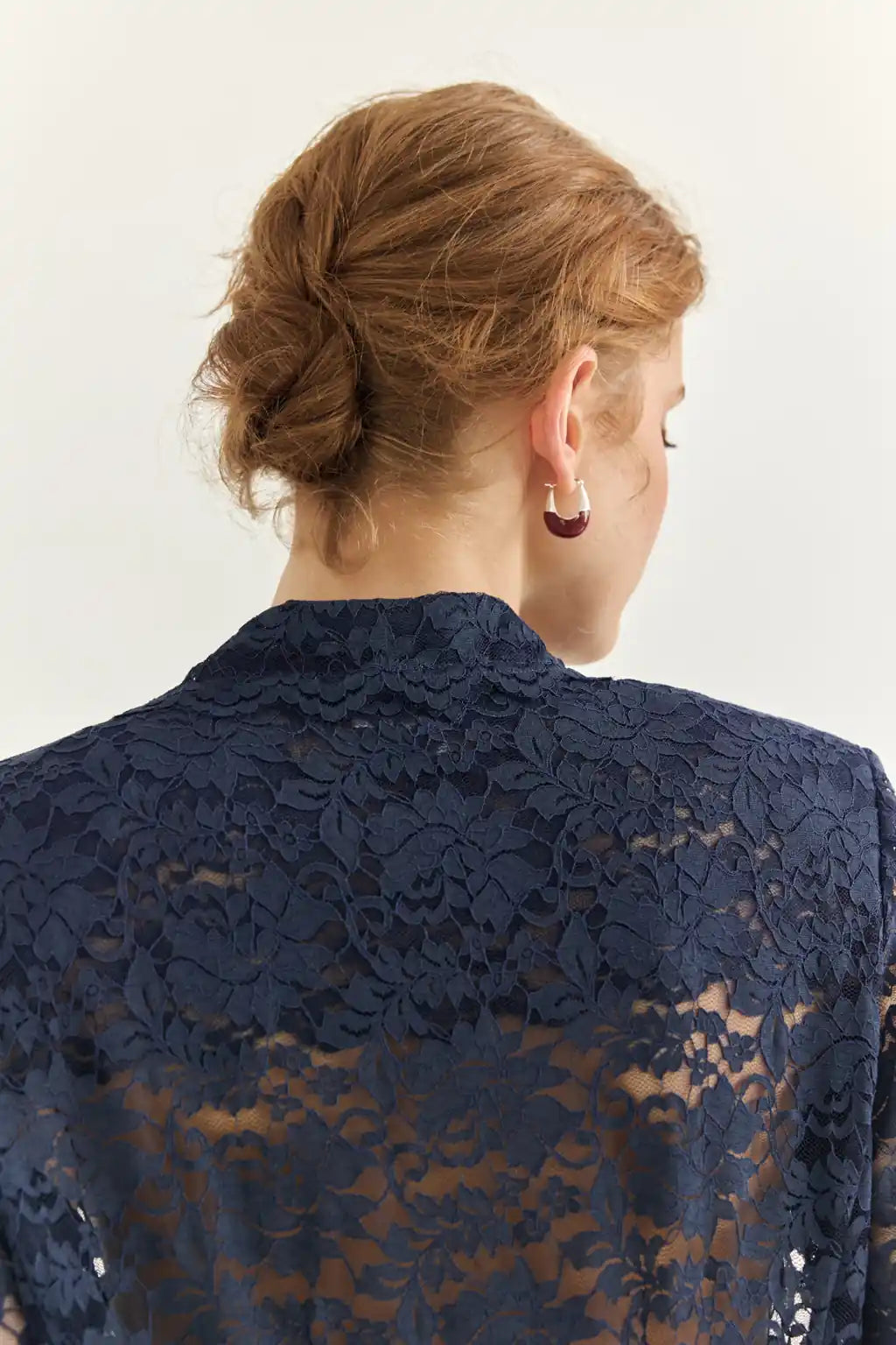Ayra Store based in New York united states of America Woman wearing AYRA Vinyl Corded Lace Jacket with notched lapel and scalloped hem paired with fluid navy blue trousers