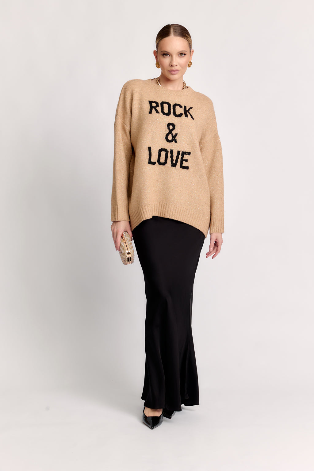 Woman wearing a beige sweater with 'Rock & Love' text on a white background
