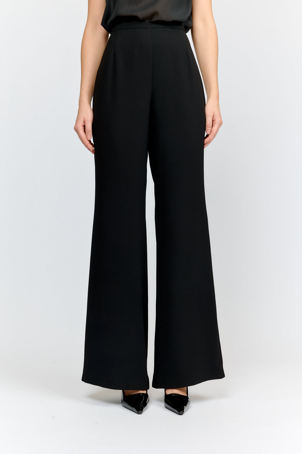 Black wide-leg pants worn by a person on a white background